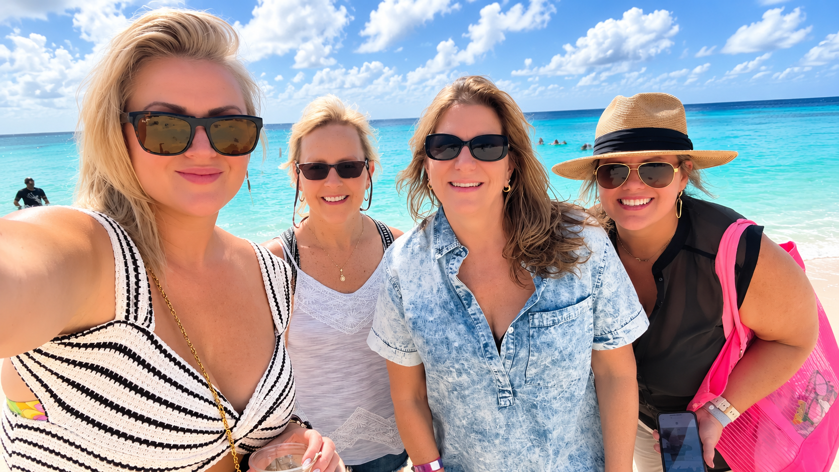 Friends posing by the ocean.